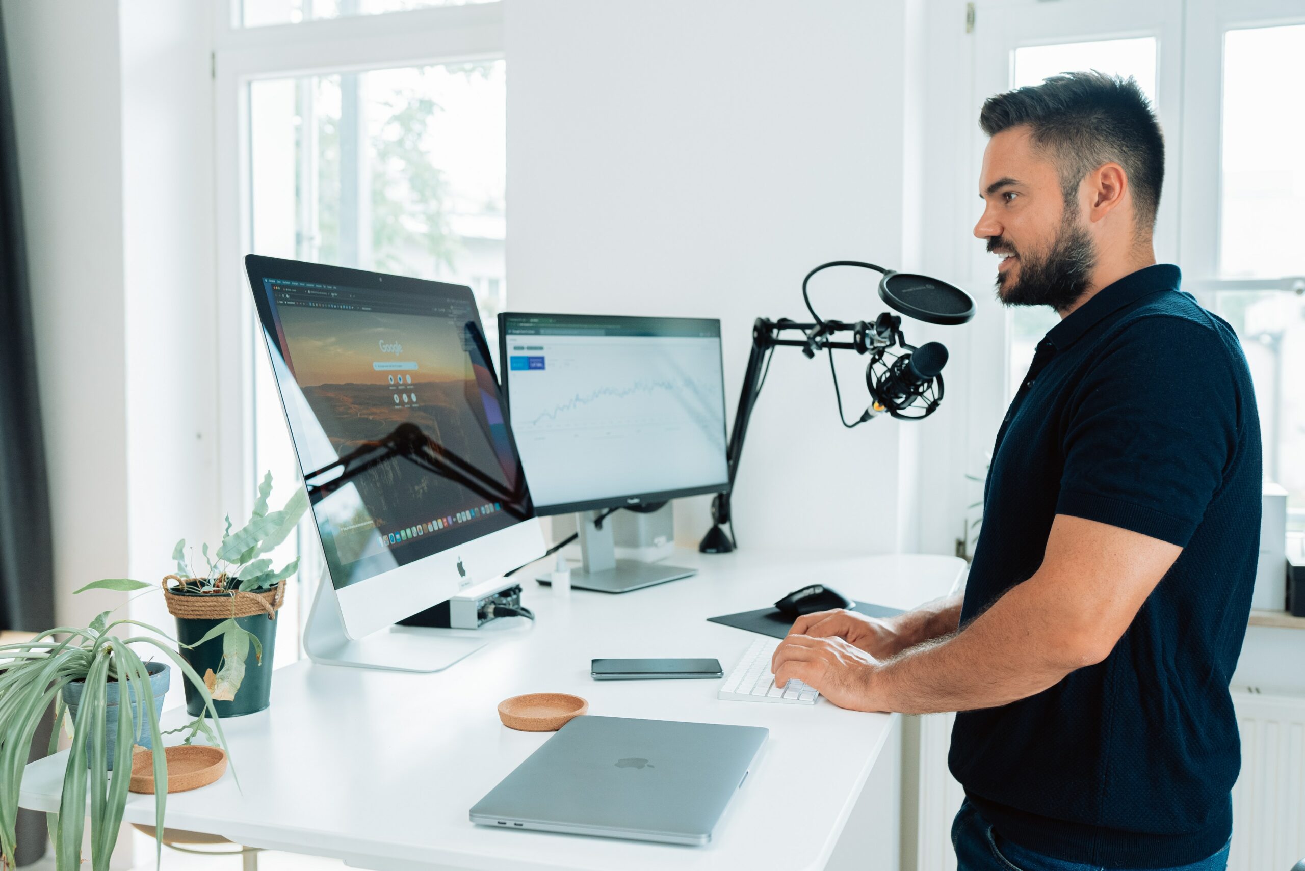 podcaster recording at white desk